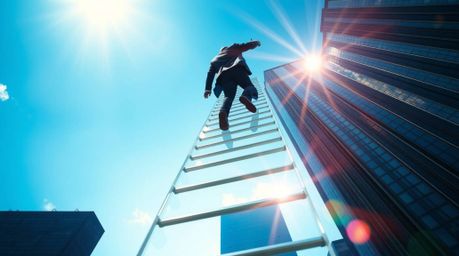 A striking image depicts a businessperson ascending a transparent ladder disappearing into a vibrant blue sky above towering 