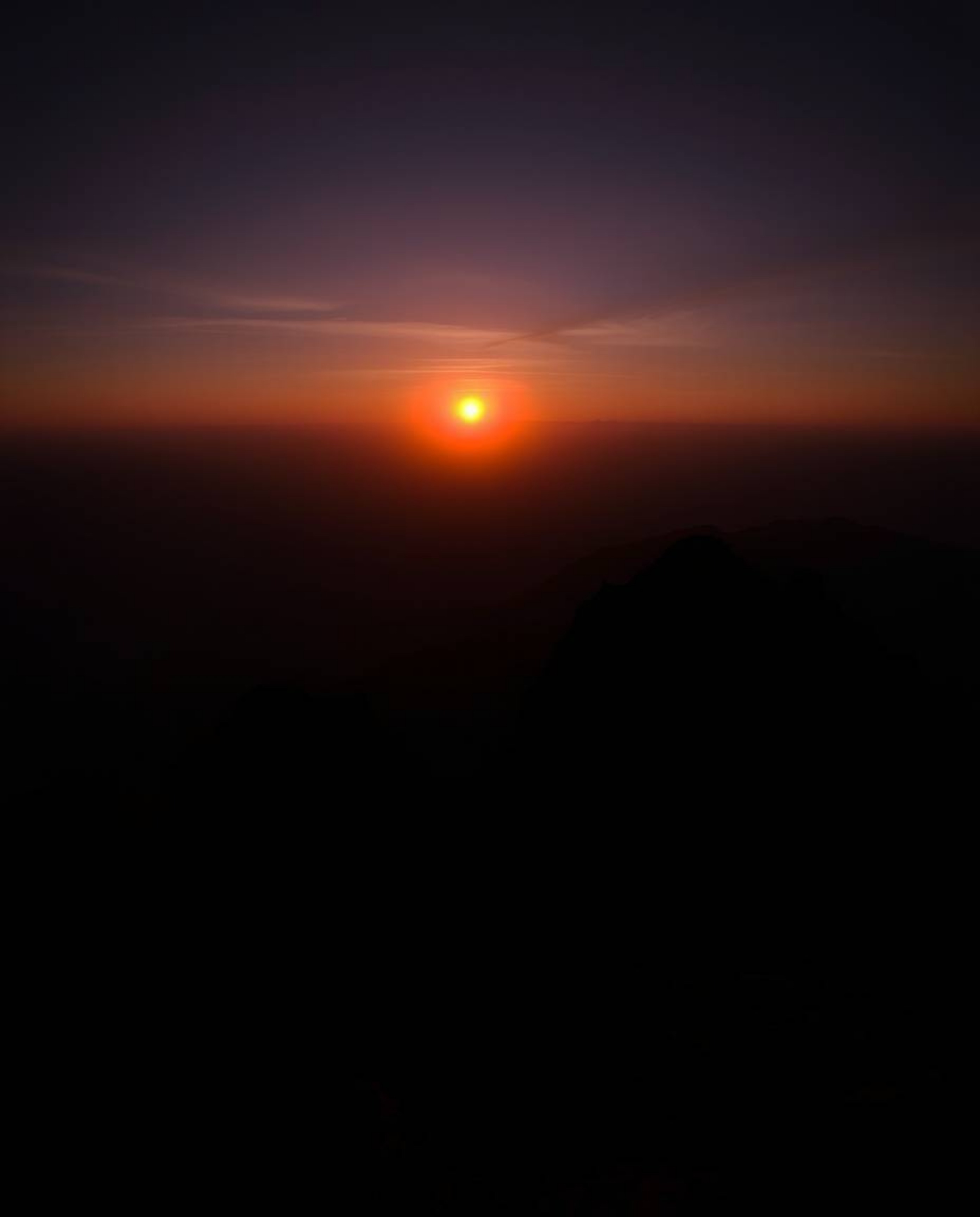 Experience a dreamy atmosphere with this stunning sunset from a high alpine peak, defined by its contrasting chiaroscuro ligh