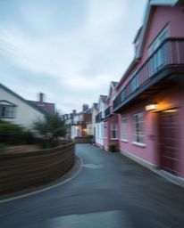 Explore the serene beauty of long exposure photography featuring a sleepy town rendered in a watercolor style. Imagine pastel