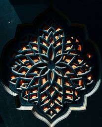 Experience the beauty of silhouetted Islamic geometric patterns deeply carved in teal stone.  Intricate details and historica