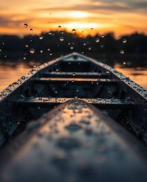 An extreme macro photograph captures a rain-soaked boat adrift on a sunset lake. The lens focuses intensely on the water drop