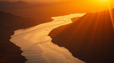 Experience the breathtaking beauty of a river delta bathed in the warm glow of twilight. This stunning image showcases a high