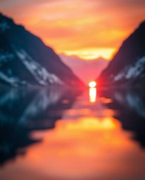 The reflection of a sunset in a glassy fjord is captured in warm golden hour light, typical of the moments just after sunrise