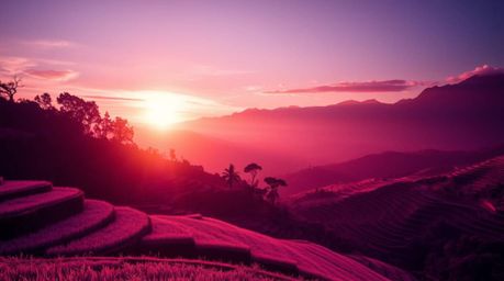 Experience a captivating surreal scene with an infrared image of a sunset over mountain rice terraces. The unique perspective
