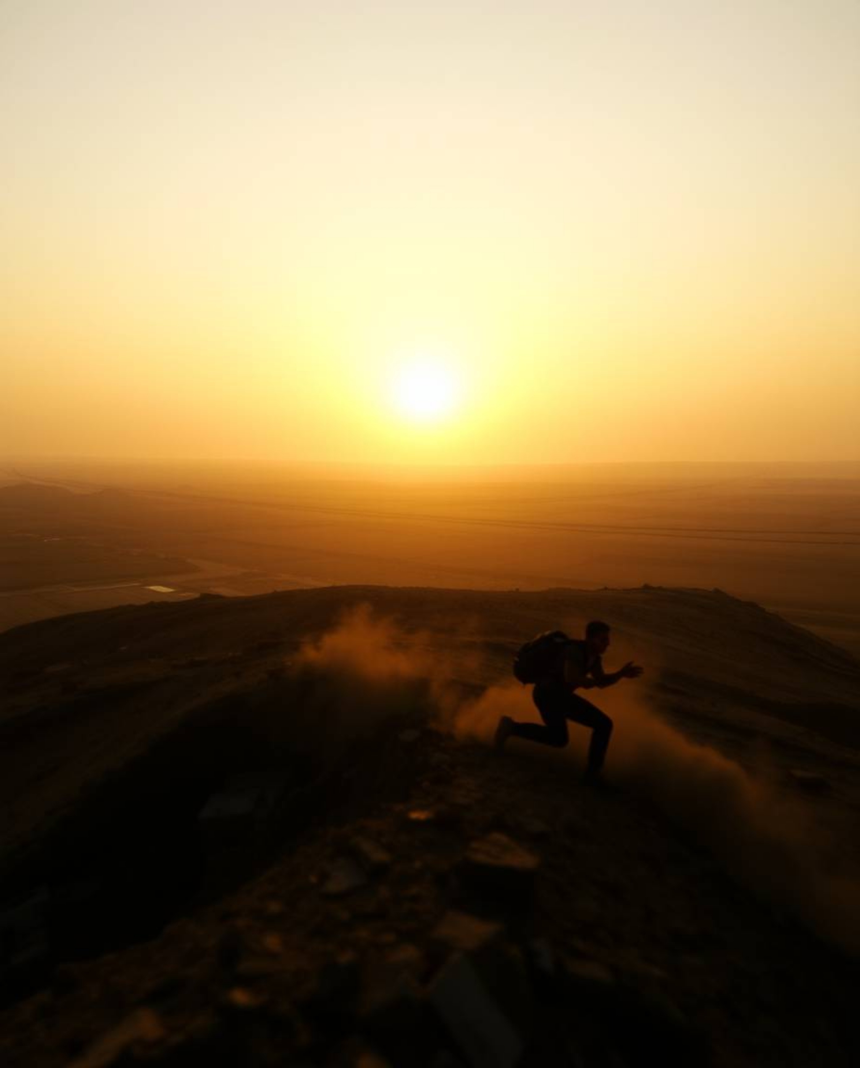 Capture the raw beauty of a sunrise over a war-torn landscape, showcasing dynamic motion and gentle soft light with diffused 