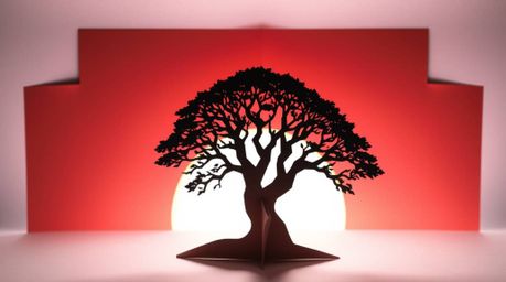 A stunning image depicting an intricate origami-style silhouette of a lone tree set against a vibrant fiery sunset.  The fold