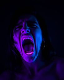 A captivating scene depicts a person screaming as their surroundings dissolve into glowing pixels, bathed in deep ultraviolet