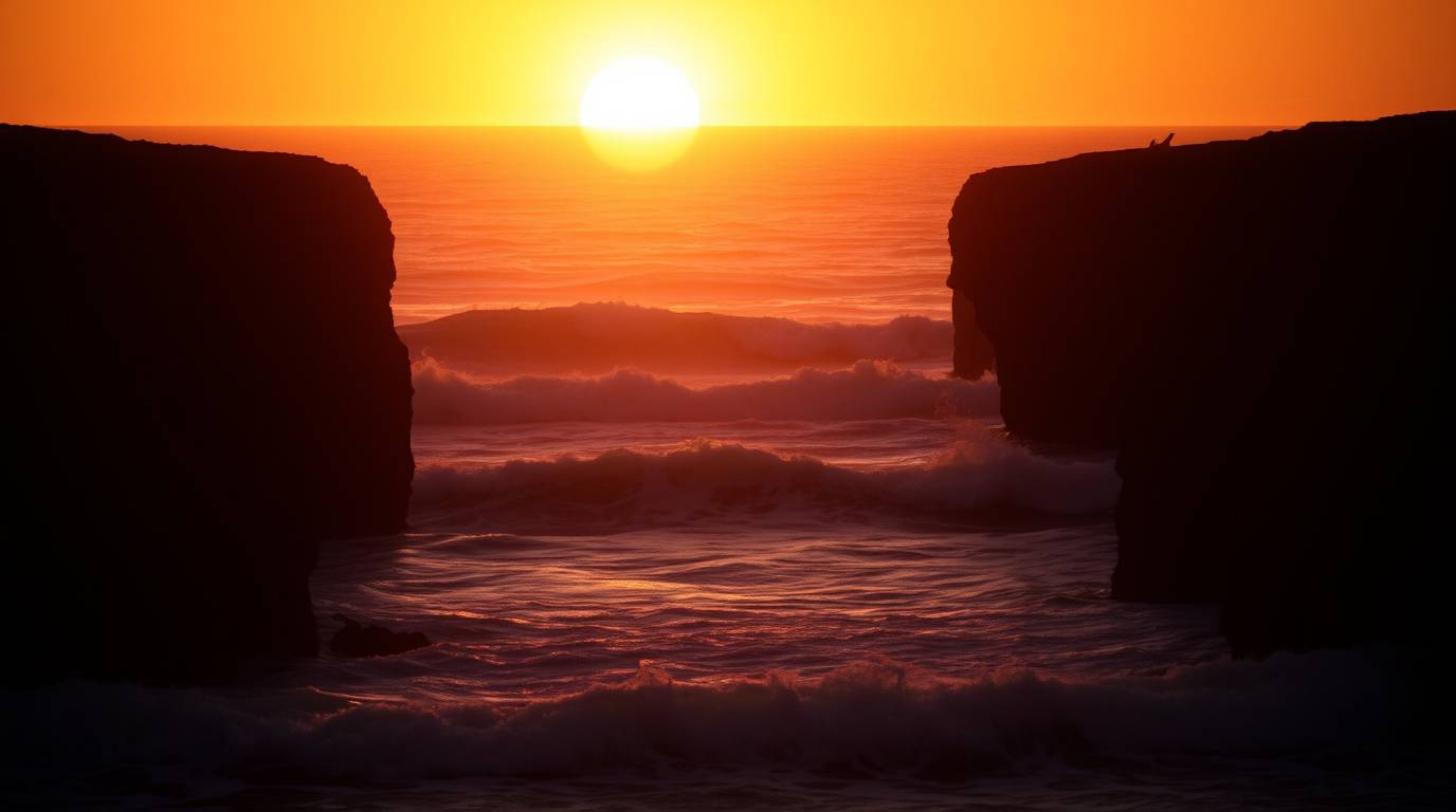 Experience the captivating beauty of professional fine art photography depicting waves crashing against cliffs under a vibran