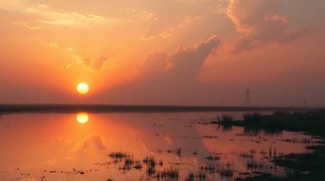 Capture the beauty of nature with this high-resolution stock photo showcasing an epic scene of a vibrant sunset mirrored in a
