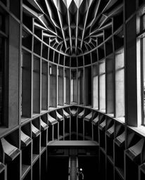 Immerse yourself in a stunning architectural color photograph rendered in intense jet black, showcasing a captivating black a