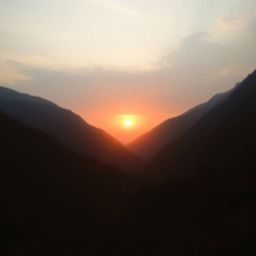 Experience the breathtaking beauty of a sunset over a serene mountain valley. This image captures a dramatic scene with soft 