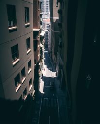 Explore a captivating surreal street scene captured from an elevated high angle, featuring buildings that fold and twist in i