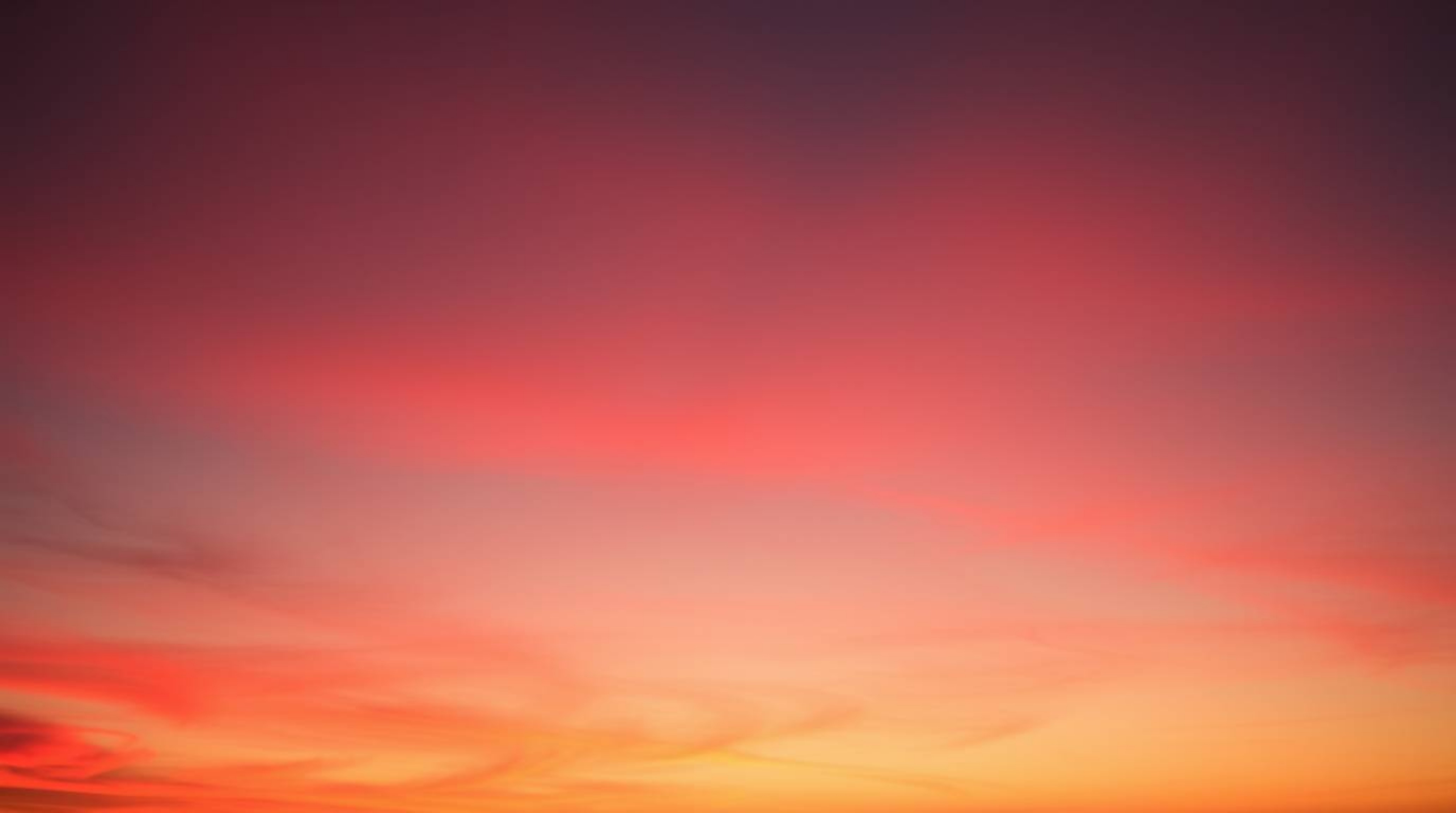 Experience the ethereal beauty of the Northern Lights subtly emerging over a captivating sunset sky. This image, rendered in