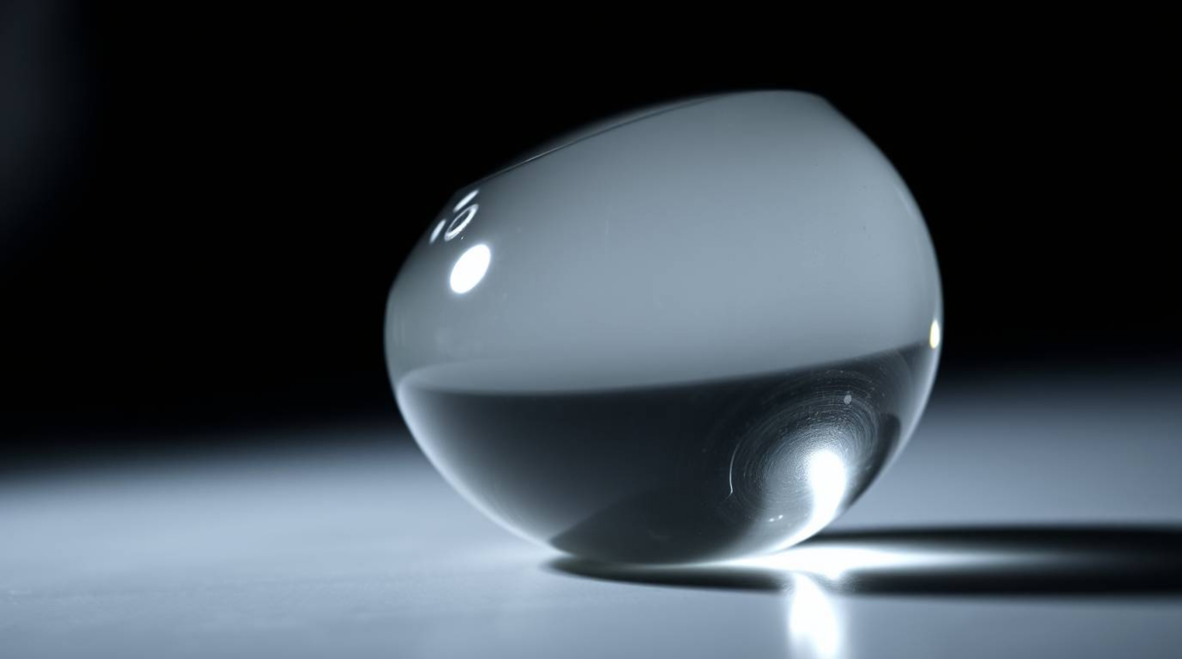 This collection features close-up details of glass objects reflecting smooth gradient textures under contrasting chiaroscuro 
