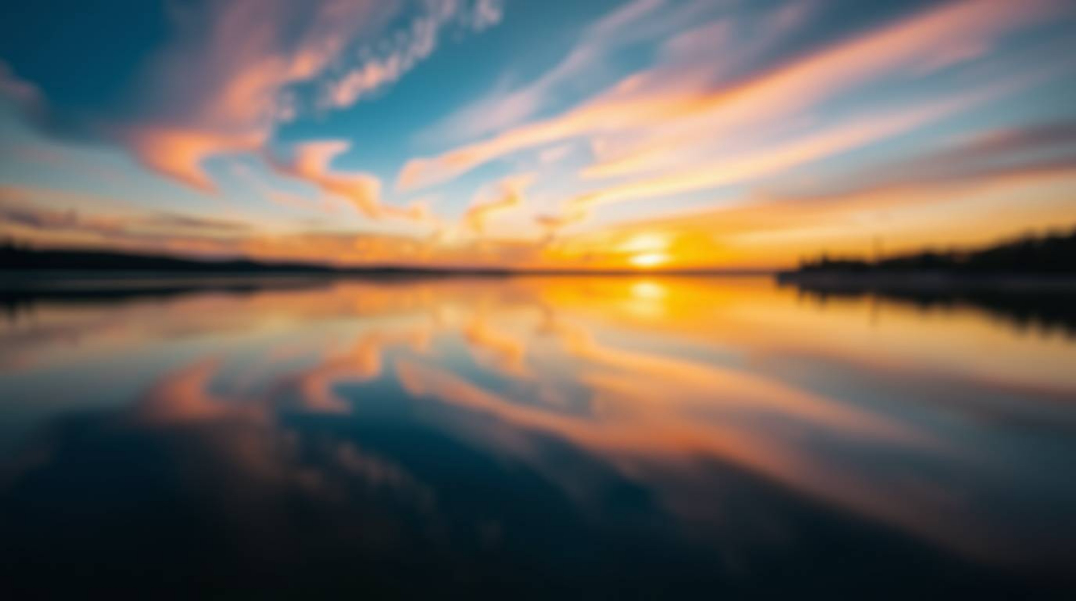 Capture the tranquility of a serene lake mirroring a vibrant sunset sky. This stunning image features a distinctly split comp