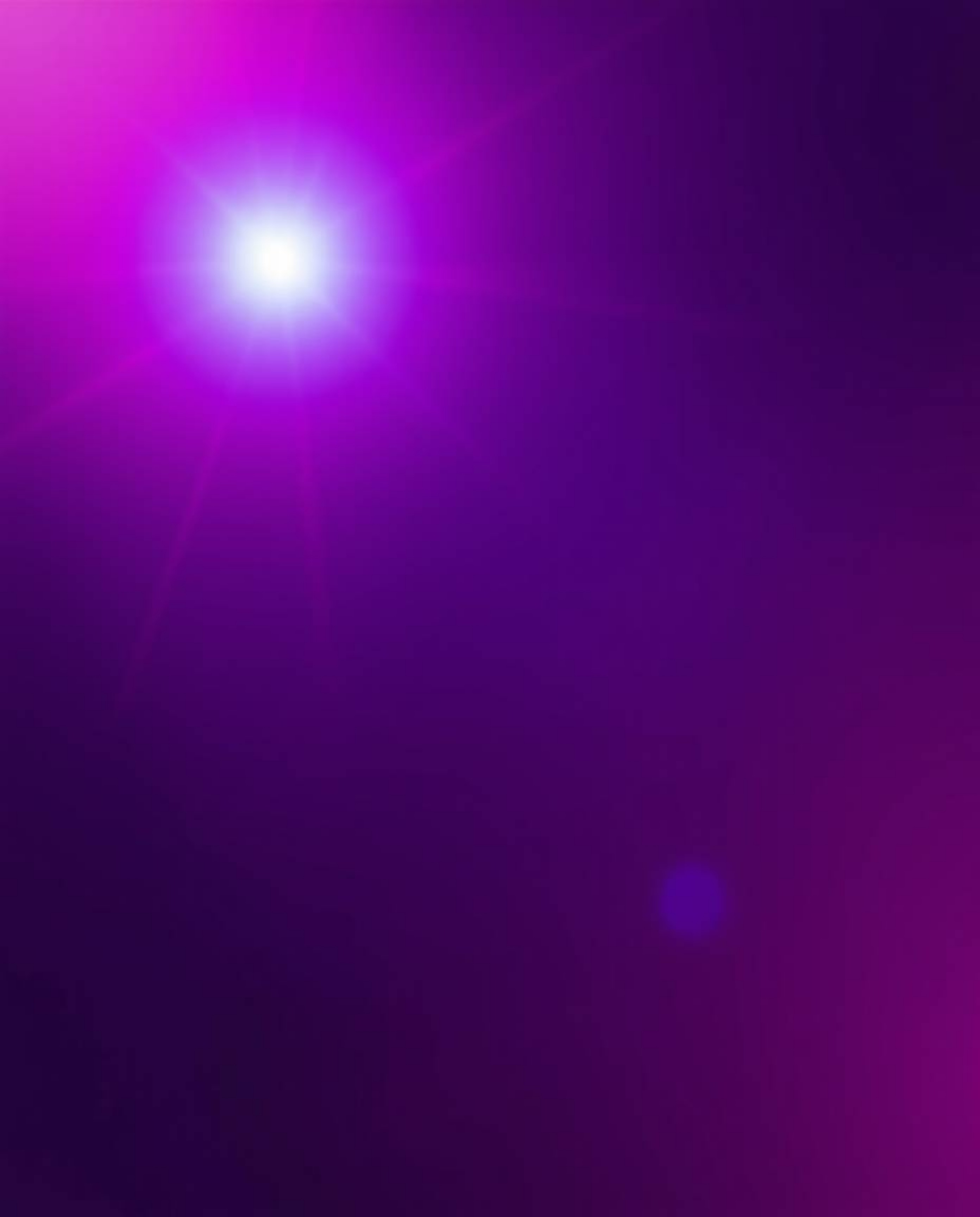 A sophisticated digital art piece featuring a vibrant lens flare in rich burgundy and deep blue tones.  Soft gradient texture