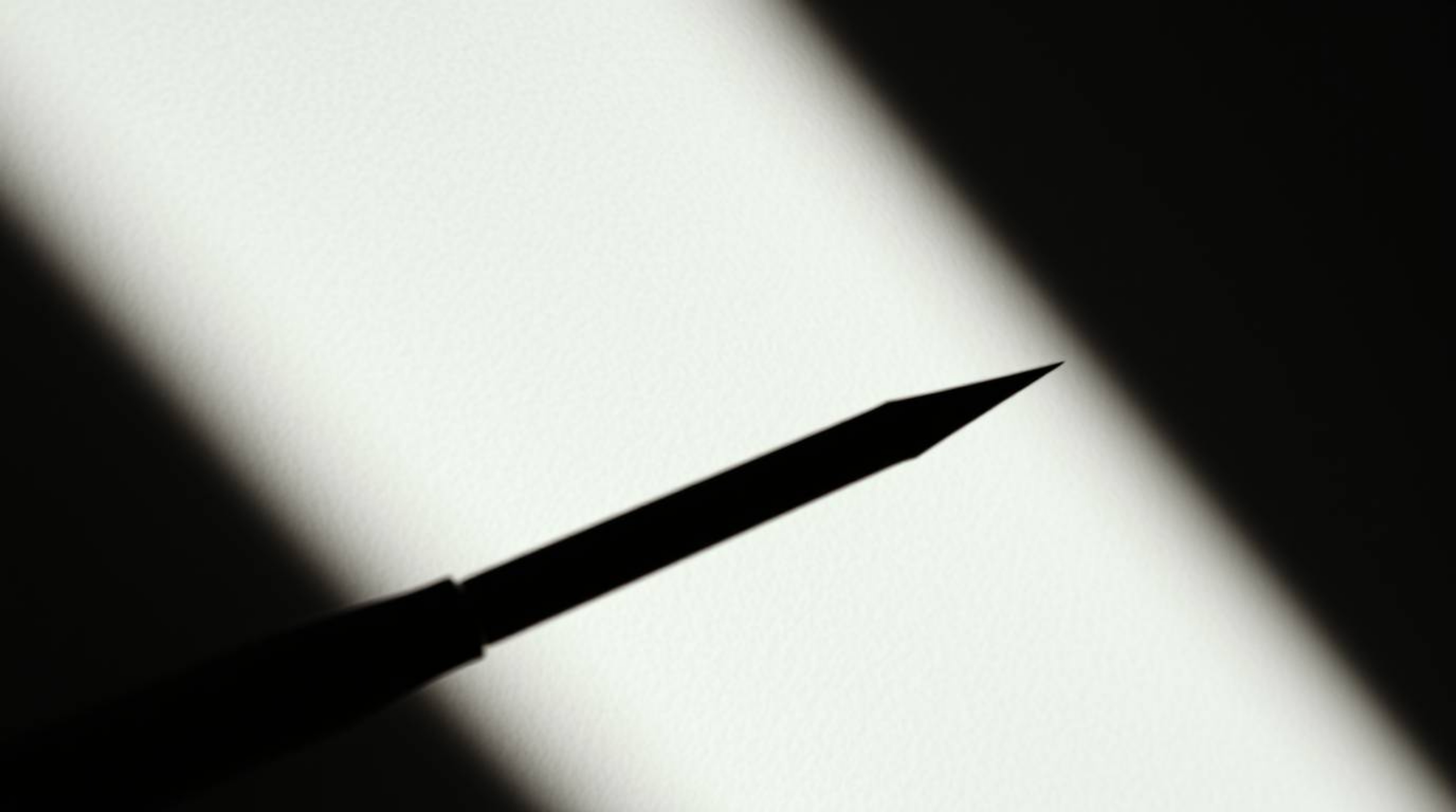 Explore the power of contrasting chiaroscuro lighting in a tight close-up shot, revealing a minimal aesthetic with strong con