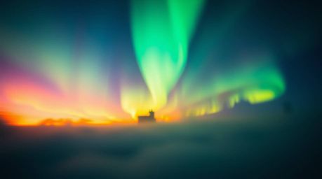 Witness the breathtaking spectacle of iridescent Northern Lights emerging over a vibrant sunset sky.  This dynamic scene feat