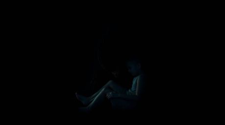 A captivating fine art photograph depicting a unique bond between a child and a monster under the bed.  The image features in