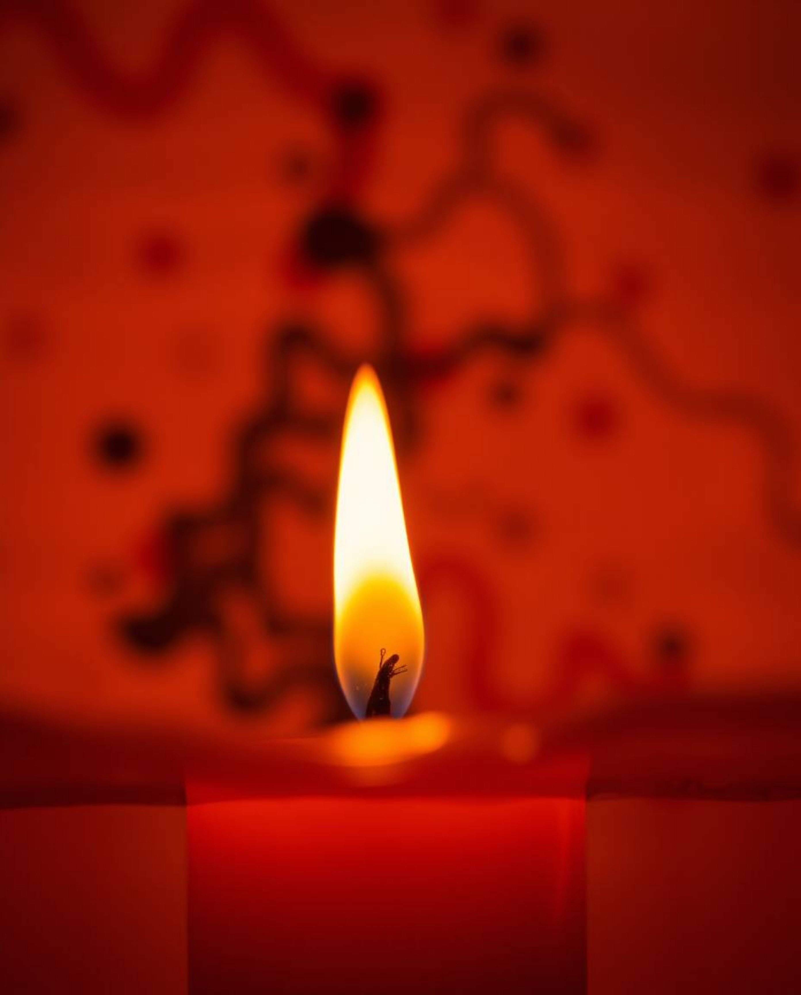 Explore captivating art created with a low angle perspective capturing warm candlelight, ink in water, and macro photography.