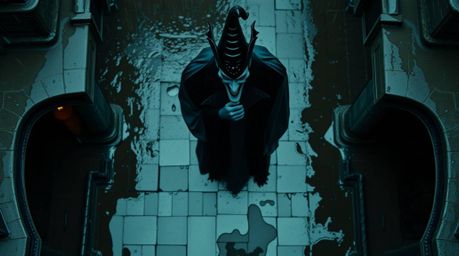 Overhead bird's eye view captures a wet, rainy scene with reflective surfaces, featuring a classic Disney villain casting a s