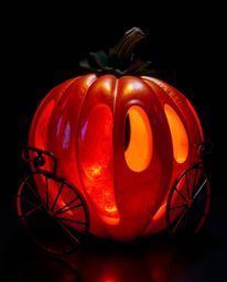 Experience a breathtaking visual spectacle as intense dramatic lighting accentuates an iridescent pumpkin undergoing a magica