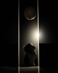 A captivating image featuring a child gazing upwards at a balloon from a low angle perspective. The scene is divided into dis