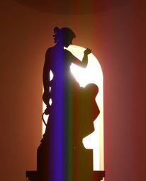 A silhouetted classical sculpture is bathed in a soft pastel backlight, exhibiting a captivating digital glitch corruption ef