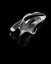 Experience the captivating beauty of contrasting chiaroscuro lighting illuminating smooth, 3D fluid shapes with metallic text