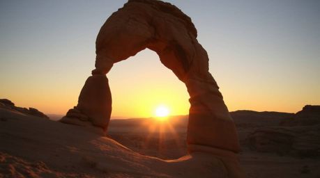 Capture the unusual beauty of a desert sunset seen through a natural rock arch with fine art photography.  This collection ex
