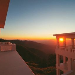 This image captures a precise architectural color photograph of a sunset over a serene mountain valley, radiating an ethereal