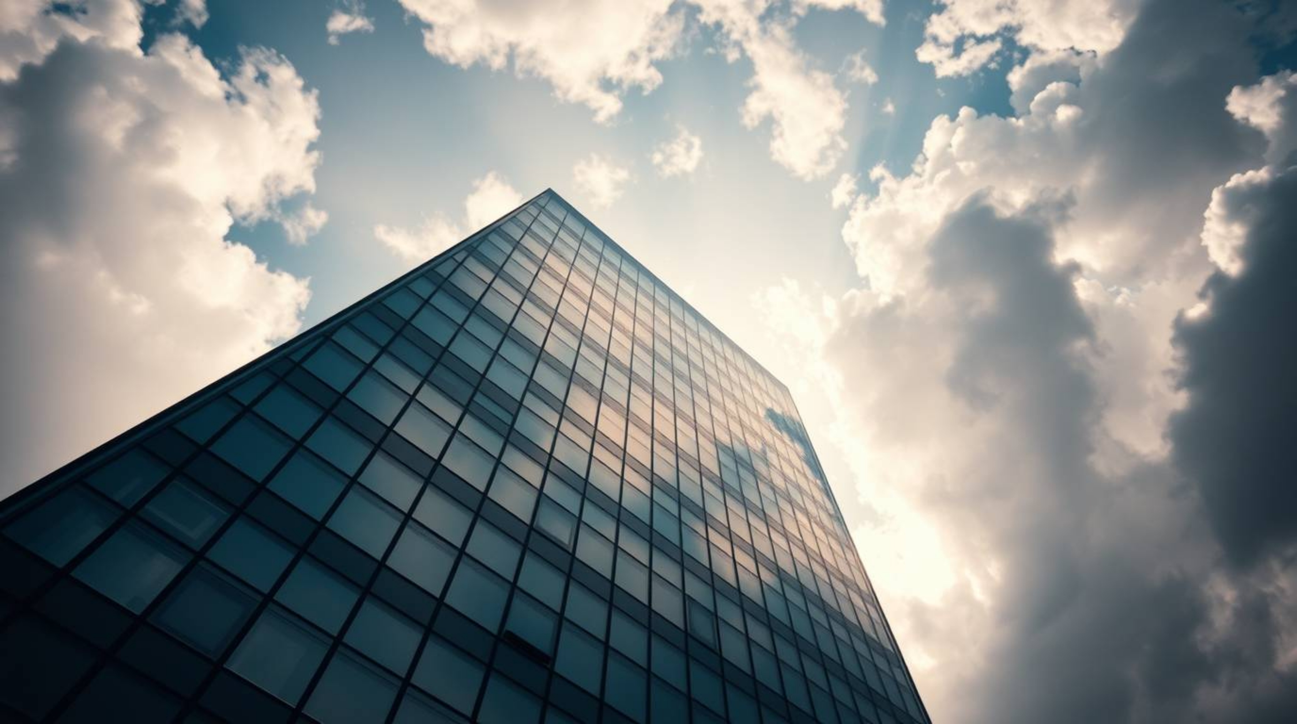 This unusual and original fine art photograph captures a modern glass building seemingly dissolving into the sky, with soft c