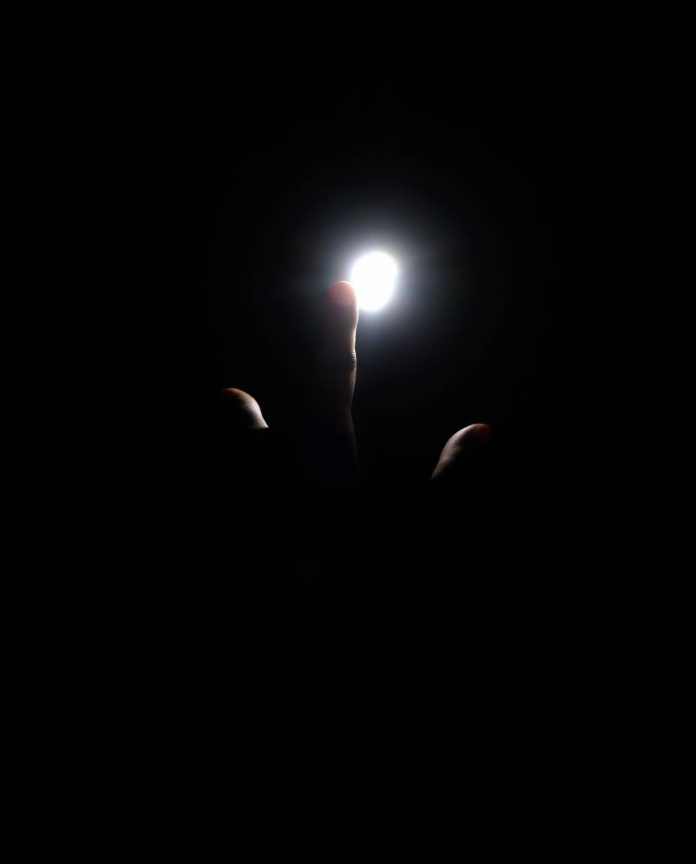 A captivating image showcasing a hand reaching from profound darkness towards a beckoning light source. The scene is characte