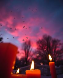 A dramatic, low-angle shot captures the enchanting scene of snowflakes falling during a vibrant sunset. Illuminated by the in