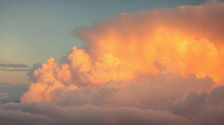 Experience the ethereal and spiritual with this depiction of thunderstorm clouds bathed in the soft, warm glow of golden hour