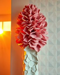 Explore a collection of artwork featuring layered papier-mâché sculptures bathed in the warm glow of golden hour light. These