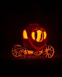 A breathtaking fine art photograph depicts a bioluminescent pumpkin magically transforming into a carriage.  Bathed in soft, 