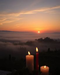This is a high-resolution stock photo of professional, commercial quality, capturing a serene sunset over the misty, rolling 