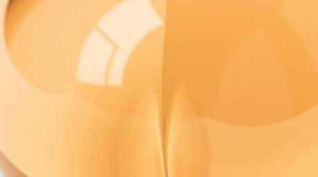 This close-up detail captures an adorable glass object reflecting smooth gradient textures with distinct split, divided secti