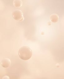 A soft cinematic 3D render showcasing translucent, fluid organic blobs gracefully floating in a hazy space. The soft focus an