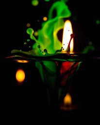 A captivating macro photograph showcasing vibrant ink splashes in water against a dramatic jet black backdrop.  The image fea