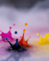 A captivating macro photograph showcases the vibrant chaos of ink swirling in water.  The image features colorful splash shap