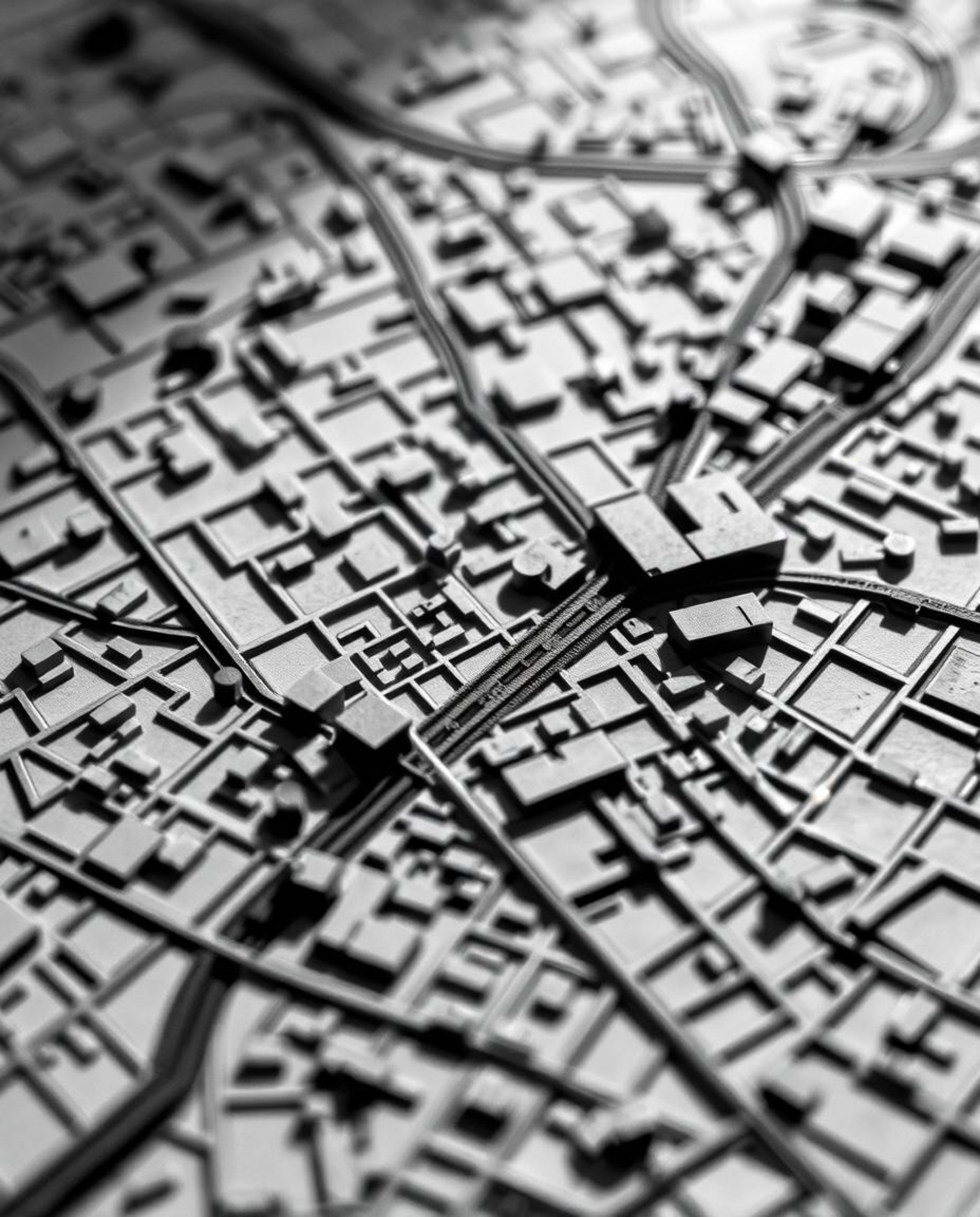 An extreme close-up macro photograph reveals the intricate details of an abstract city map composed of geometric shapes.  The