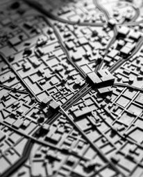 An extreme close-up macro photograph reveals the intricate details of an abstract city map composed of geometric shapes.  The