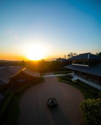 Experience a serene Zen garden at sunset from a compelling high-angle perspective. This photograph is distinctly split into d