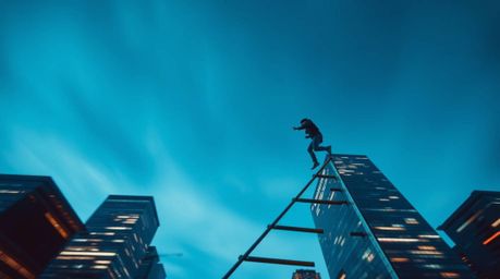 A captivating long-exposure photograph depicts a businessperson ascending a transparent ladder into a vibrant blue sky above 