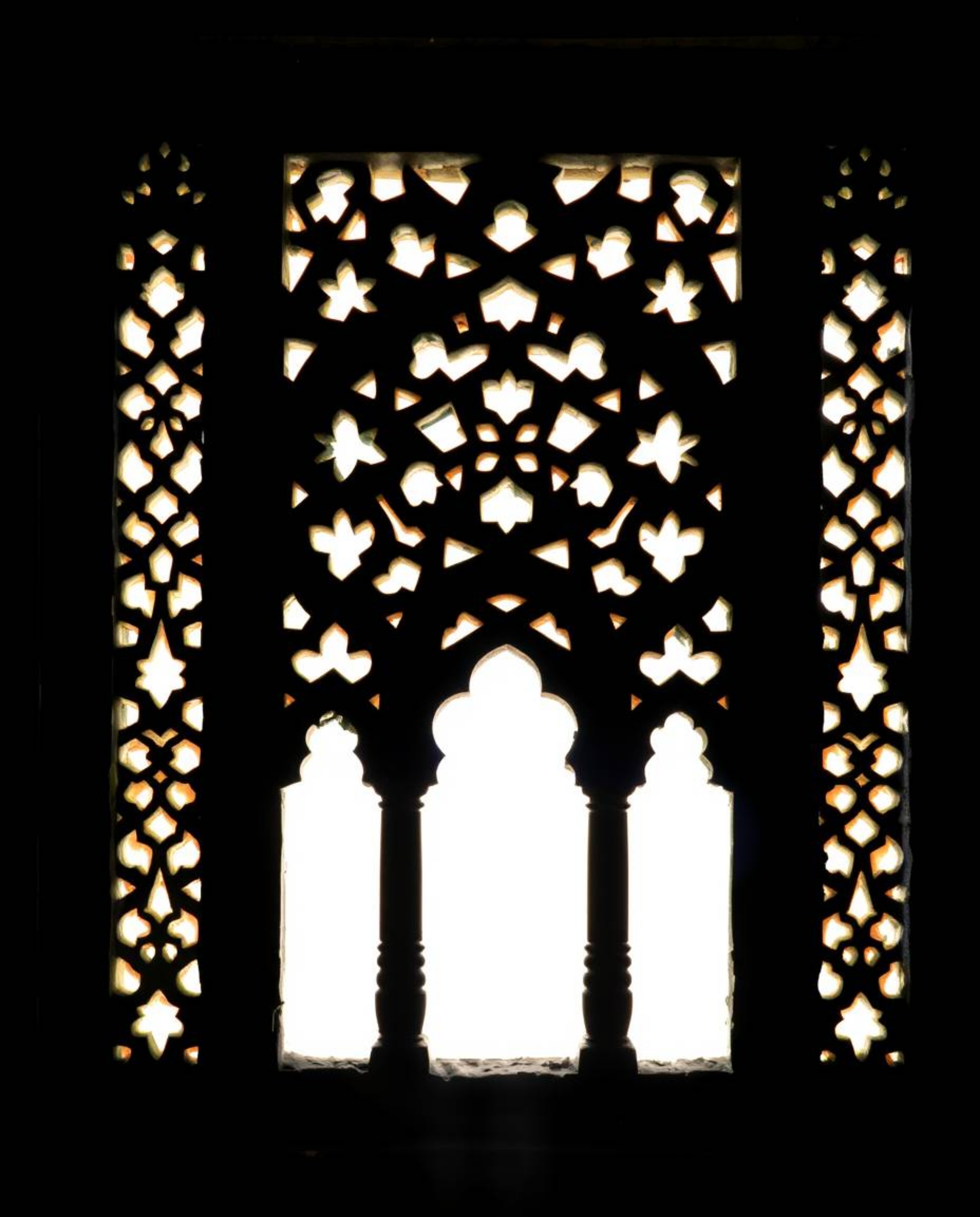 Explore the timeless elegance of silhouetted Islamic geometric stone carvings, captured in classic black and white. The intri