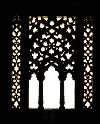 Explore the timeless elegance of silhouetted Islamic geometric stone carvings, captured in classic black and white. The intri