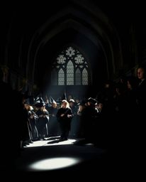 A captivating image depicts a magical school brimming with young wizards, dramatically lit to showcase intense jet black and 