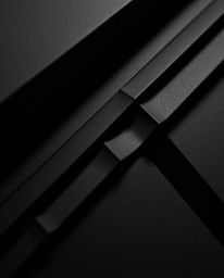 An extreme macro photograph showcases a pure black, 3D geometric pattern reminiscent of folded paper.  The monochrome image e